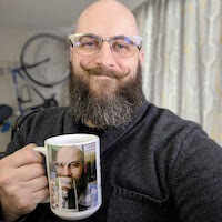a picture of the author drinking from a coffee mug with a picture of himself drinking from a coffee mug with a picture of himself drinking from a coffee mug. This joke has gone on for far too long, but he shows no signs of ceasing to make more mugs.